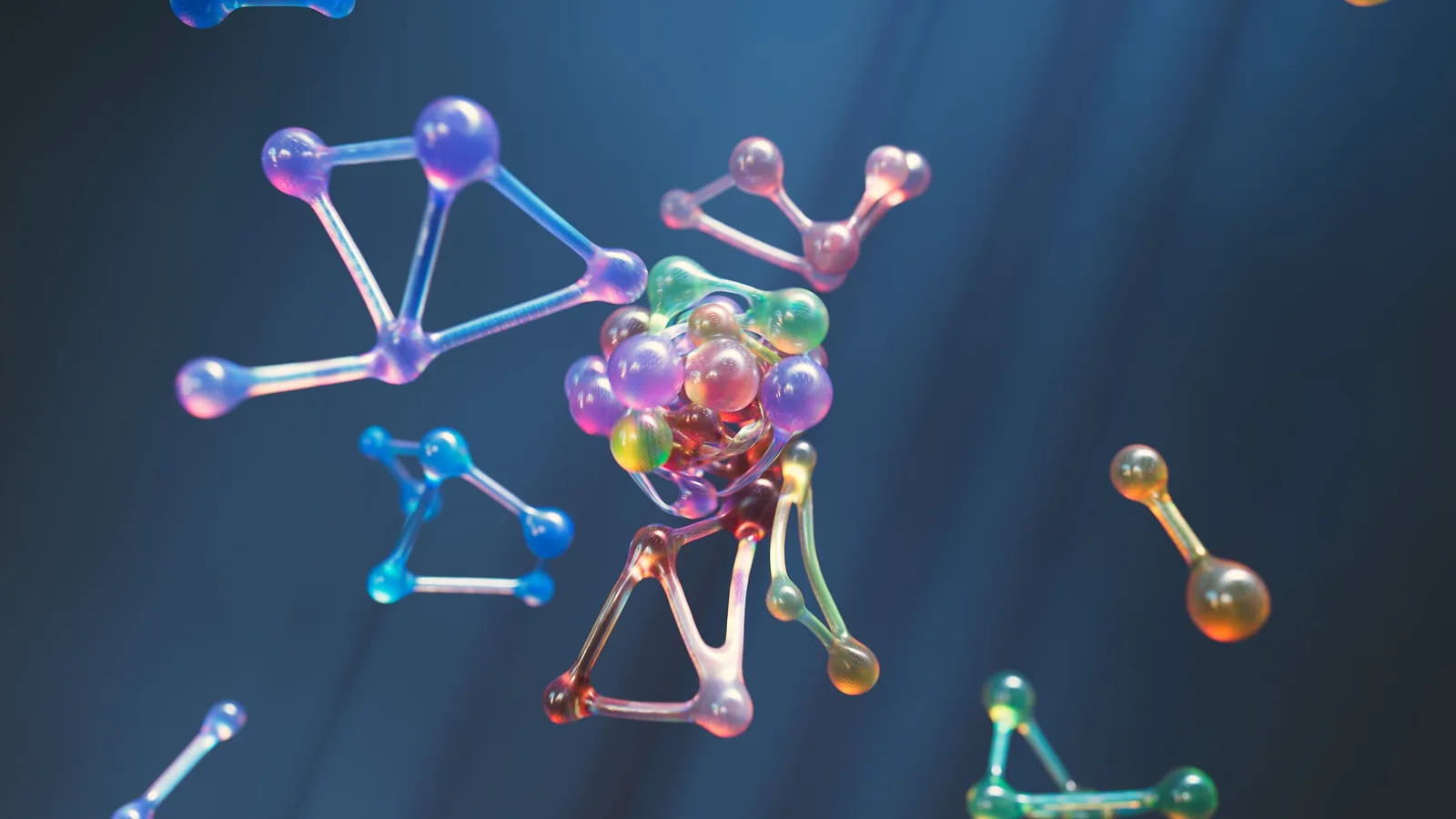 Abstract 3D render of translucent glass spheres linked in triangular lattices, in blue, pink and amber