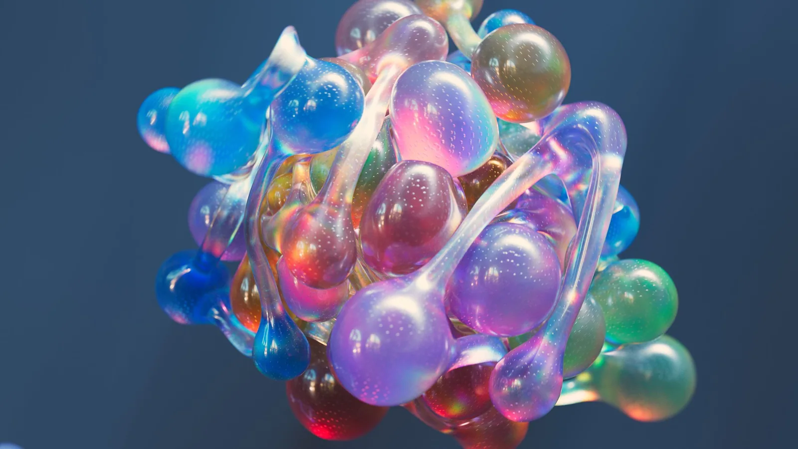Abstract 3D render of a cluster of translucent glass spheres in blue, violet and coral, linked by thin stems
